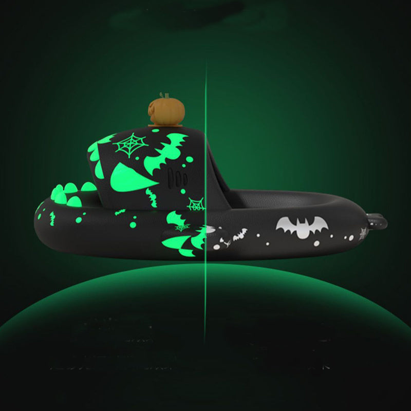 Glowing Halloween-themed inflatable pool float with pumpkins on a dark background